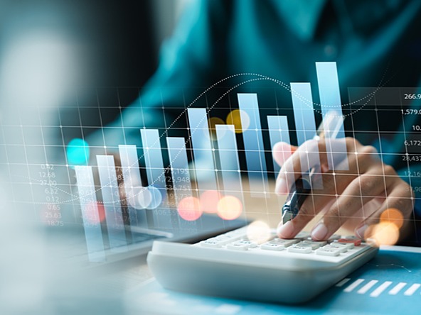 person using calculator overlaid with graphs